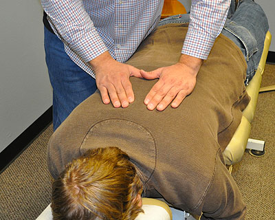 Dr. Ungerank performs a thoracic spine adjustment.